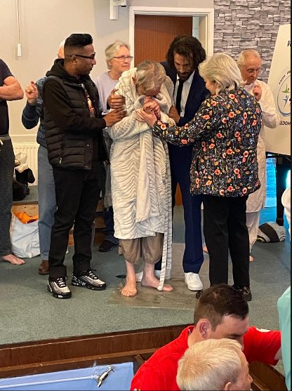 Family and staff supporting a resident at his baptism.